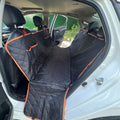 Waterproof dog car seat cover installed as a hammock in a car back seat